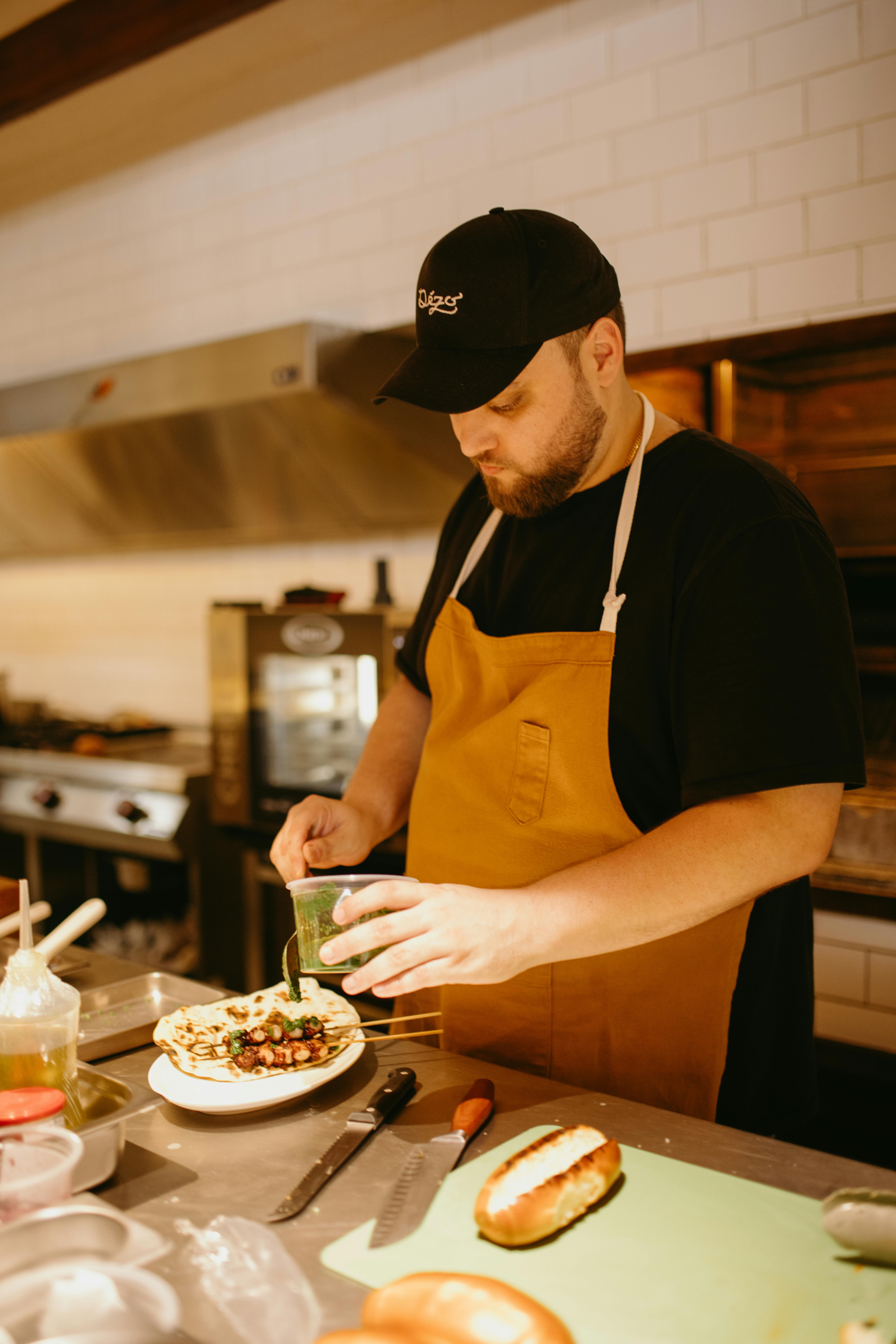 Chef plating food in a working kitchen